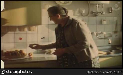 Grandma in the kitchen with apples
