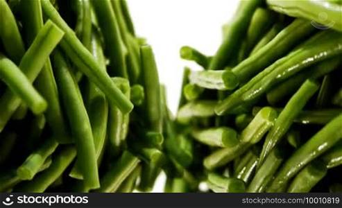 Green beans rotate in opposite directions, shot with depth of field effects