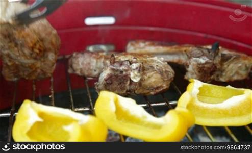 Grilling at summer weekend. Fresh steaks preparing on grill