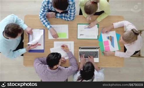 Group of multiethnic busy people working in an office, top view