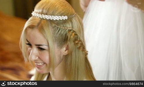 Hairdresser putting on bridal veil