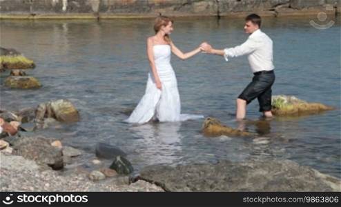 Happy bride and groom on the beach