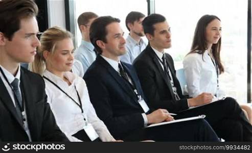 Happy business group of people clapping hands during a meeting conference