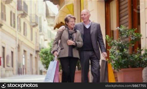 Happy people, leisure, lifestyle, senior, old man and woman shopping. Seniors walking and having fun in city street. 1 of 7