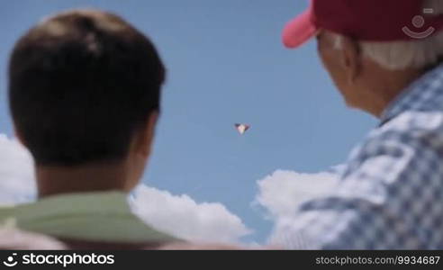 Happy tourists on holidays, during vacations. Hispanic people traveling in Havana, Cuba. Grandpa and grandson having fun. Family with grandfather and kid, boy with kite, child playing with toy