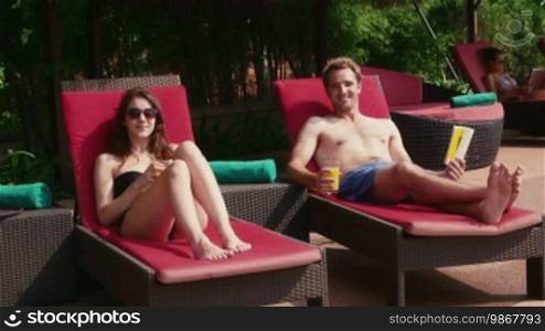 Happy young people, fun, leisure, lifestyle, vacations and relax near resort swimming pool, man and woman, using laptop pc and reading book in hotel during honeymoon. Portrait smiling at camera, 8 of 27