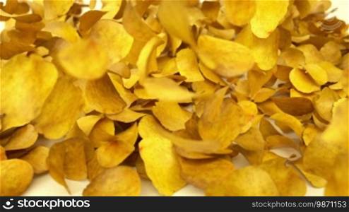 Heap of potato chips falling down or dropping