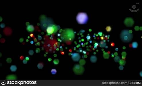 High definition animated loop of multi-coloured glitter particles rising over a dark background.