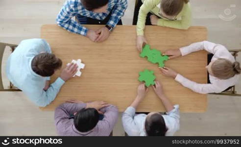 Hipster business successful teamwork concept, business group assembling jigsaw puzzle