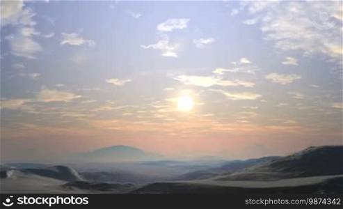 In the vast blue sky, small white clouds. The bright sun slowly sets behind the horizon, covered in hot summer haze. Over the hills and lowlands, light fog. Sunset colors the landscape in reddish tones.
