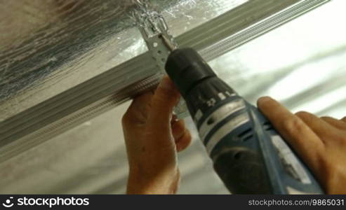 Installation of drywall - working with electric screw gun