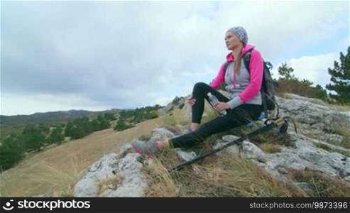 JIB CRANE: Day hiking in Crimean mountains, woman hiker enjoying view of amazing Ai-Petri plateau
