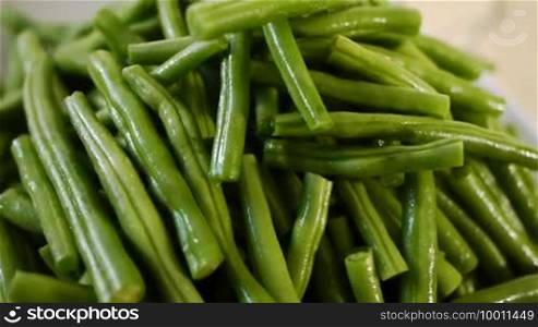 Lots of green beans are recorded turning horizontally