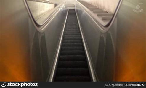 Low angle shot of empty escalator in underground with steps moving up