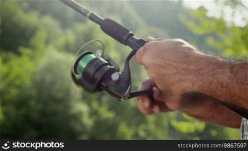 Man and sports, mid adult fisherman on holidays on river, detail of hand and fishing reel. Part 4 of 8