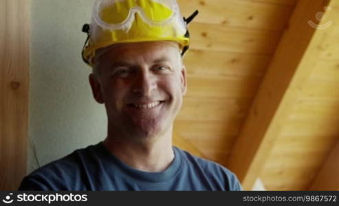 Man in construction site, portrait of happy manual worker smiling at camera. Part 6 of 8