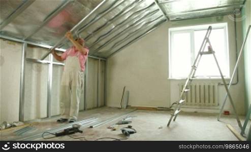 Man installing plasterboard walls in the house
