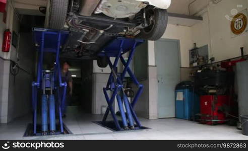 Mechanic checking a car failure. Looking for a mechanical fault or damage. Repairman testing a vehicle.