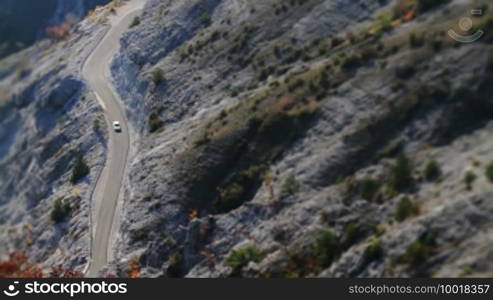 Medium shot of a mountain surface with a serpentine road