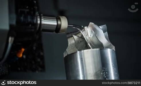 Metalworking CNC milling machine. Cutting metal modern processing technology. Small depth of field. Warning - authentic shooting in challenging conditions. A little bit grain and maybe blurred.