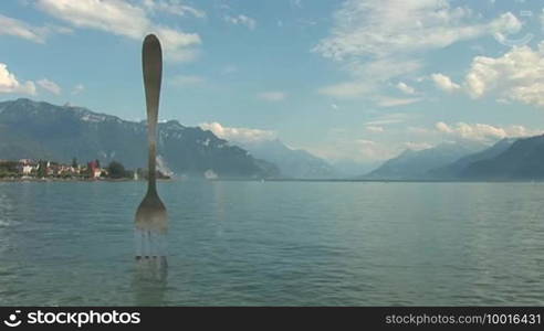 Modern sculpture - a fork sticking out of Lake Geneva