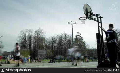 MOSCOW - May 6: Teenagers playing basketball in a city park. Time lapse at Moscow spring festival in Luzhniki on May 6, 2013 in Moscow, Russia.