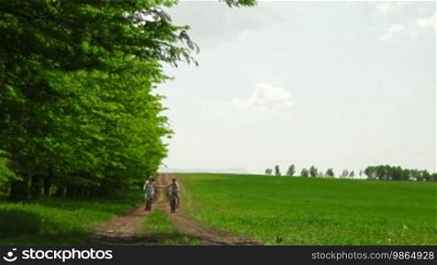 Mother and child riding bikes down a country lane