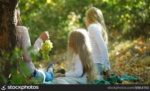 Mother and two daughters spending time together in the park