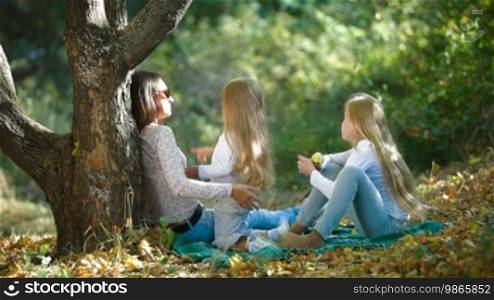 Mother and two daughters spending time together in the park