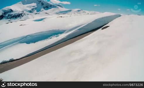 Mountain road in Norway with high snow wall