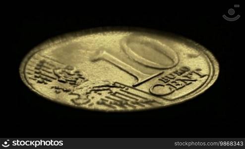 Moving light illuminating 10 Euro cents coin