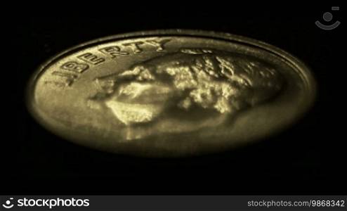 Moving light illuminating United States one dime coin