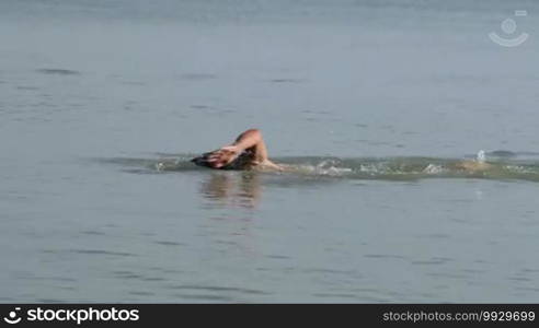 Muscular swimmer in the lake