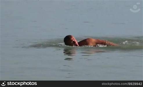 Muscular swimmer in the lake