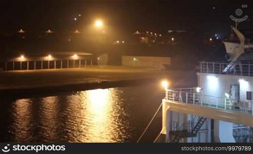 Night lights illuminate the seaport and cargo ship