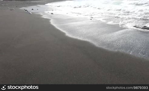 Ocean waves and beach with black volcanic sand, Canary Islands, Fuerteventura, Spain