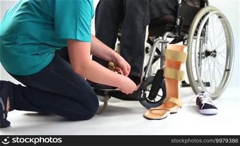 Orthopedic equipment for a young man in a wheelchair.