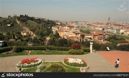 Pan from cultivated hill to Tuscan city