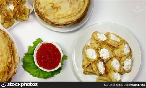 Pancakes on dining table - a symbol of the Orthodox Maslenitsa. Dolly Shot