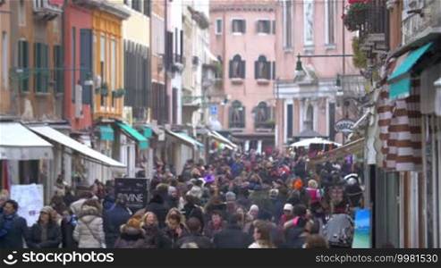 Pedestrian street in Venice, Italy crowded with people. Shot of daily life of the city.