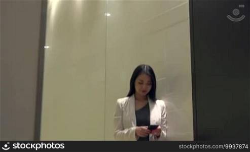 People and technology in office building. Japanese female manager. Asian businesswoman, elegant girl, woman at work, talking with mobile phone, telephone during break