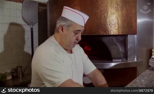 People at work, man working, food preparation, job, profession. Portrait of happy professional cook smiling, baker, skilled chef making pizza in Italian restaurant kitchen. 8 of 14
