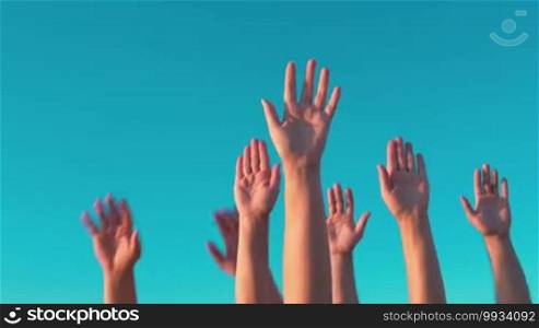 People raising hands on blue sky background. Voting, democracy or volunteering concept