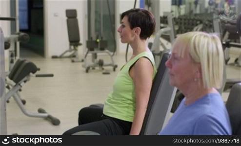 People training in fitness club, gym, and sport activity. Two women working out with wellness equipment. 27 of 27