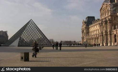 People walking in front of Louvre Museum. Please only editorial use.