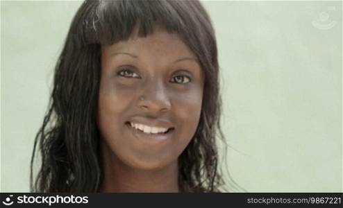 Portrait of a pretty African American girl smiling and looking at the camera