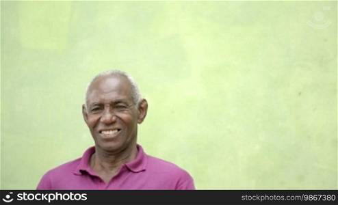 Portrait of old people, happy senior African American man with white hair looking at camera and smiling. Sequence