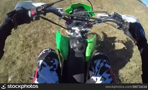 PoV: Enduro racer in motorcycle protective gear riding dirt bike off-road action camera mounted on the chest