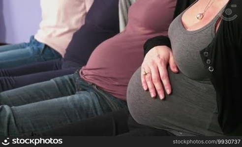 Pregnant women showing bellies and female hands touching them, group of moms with expectant tummies in line, mothers during pregnancy. Maternity, motherhood, new life and fertility