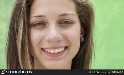 Pretty girl smiling, portrait of happy young Hispanic teen looking at camera